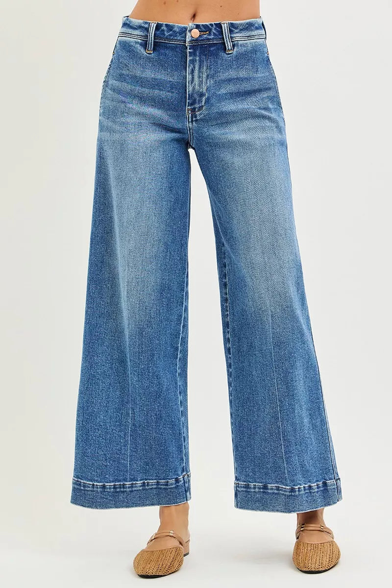 Blue jeans worn by a person on a white background