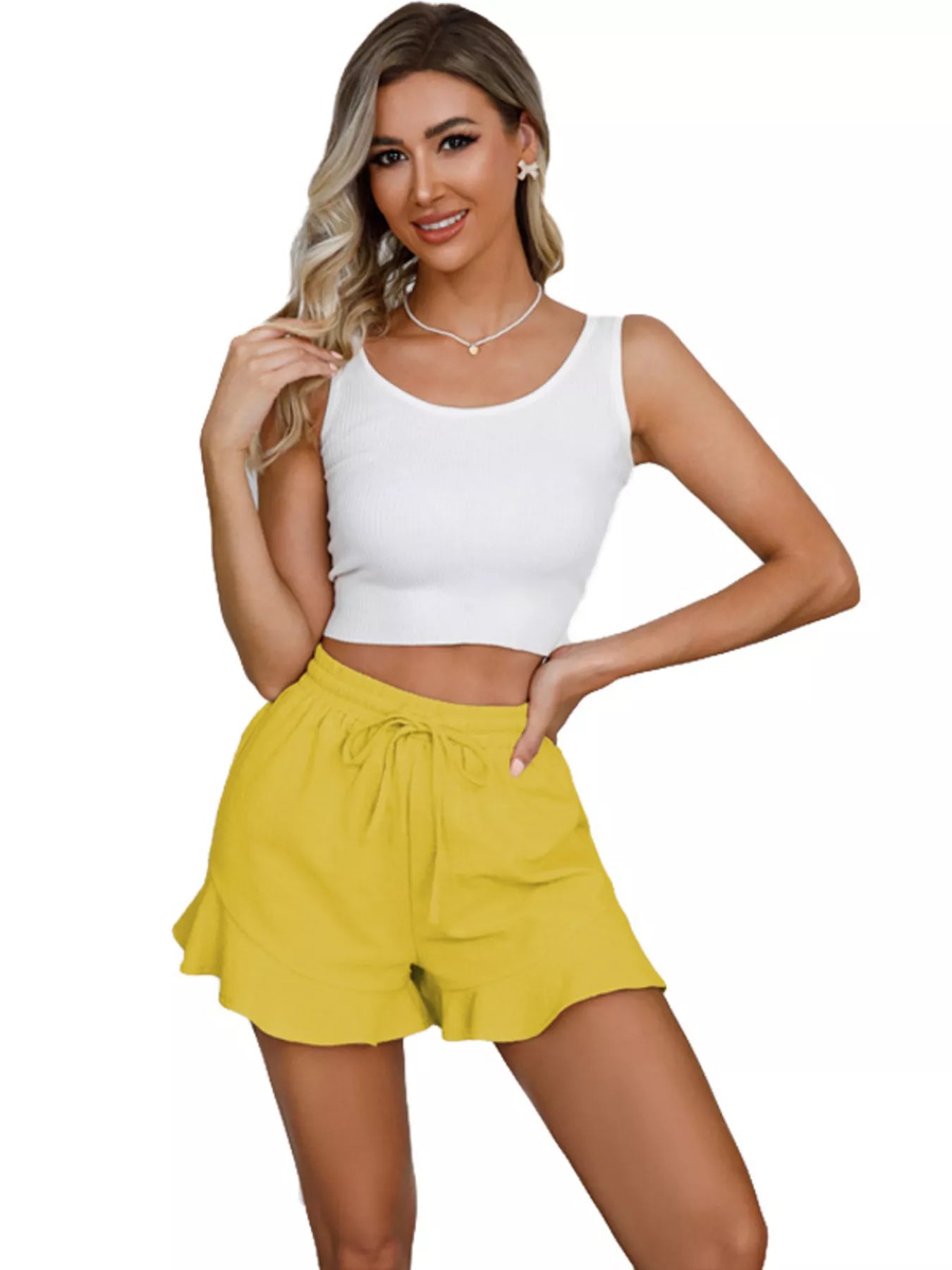 Woman wearing a white tank top and yellow shorts on a white background