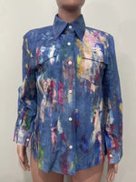 Mannequin wearing a colorful, abstract-patterned shirt against a plain background