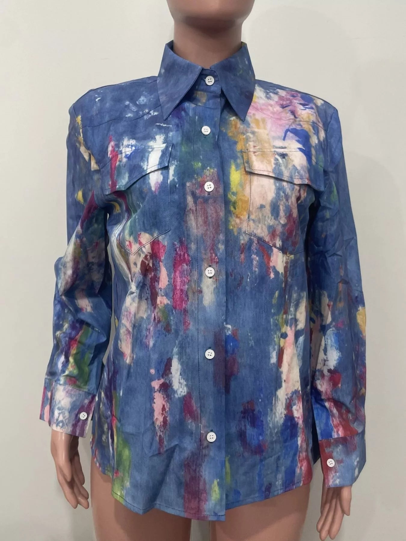 Mannequin wearing a colorful, abstract-patterned shirt against a plain background