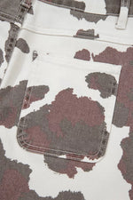 Close-up of a camouflage-patterned fabric with a pocket detail.