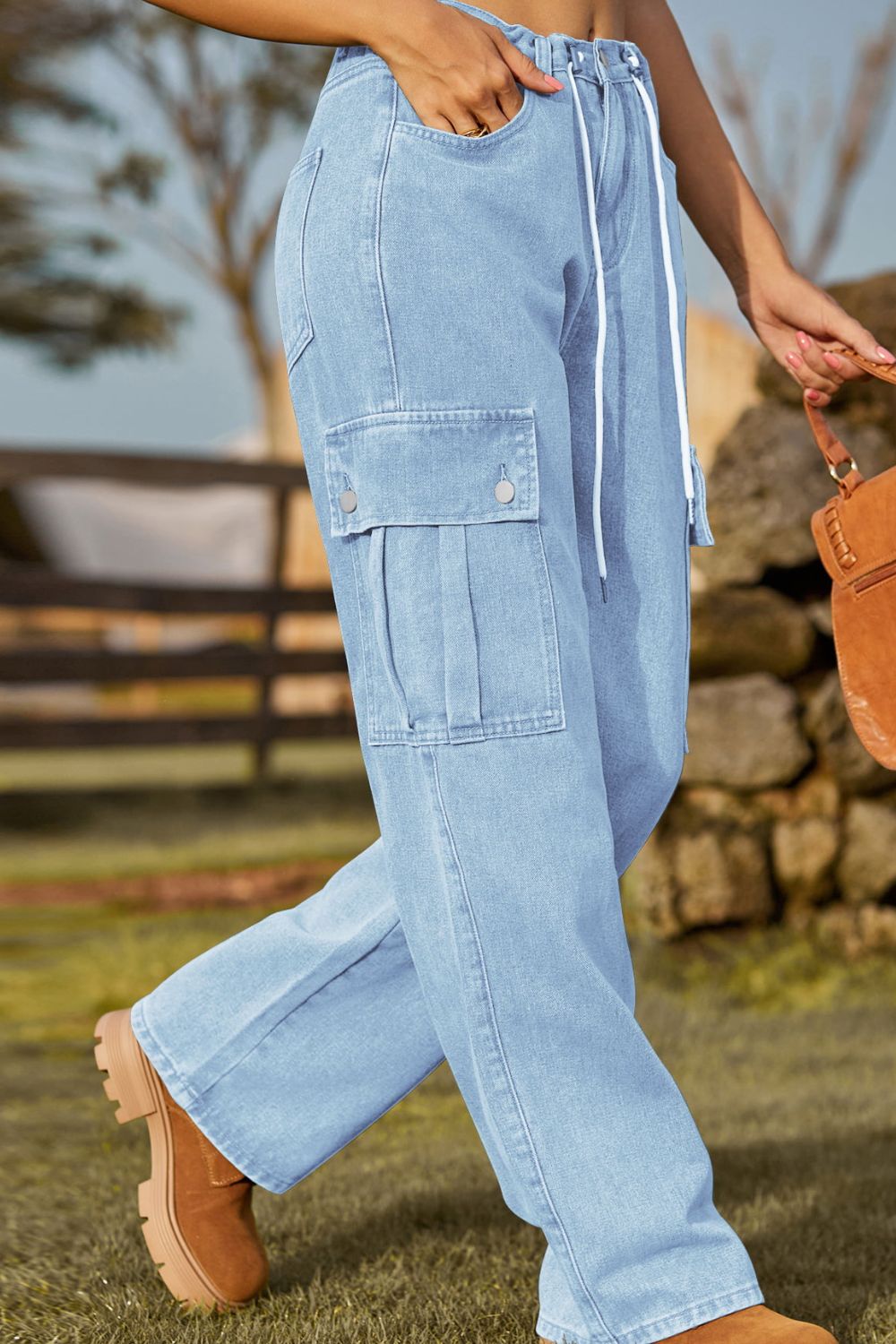 Light blue cargo pants worn by a person outdoors with a blurred background