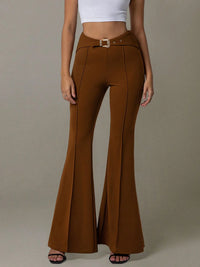 Brown flared pants worn by a person on a plain background