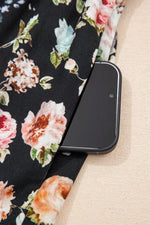 Smartphone on a floral fabric surface