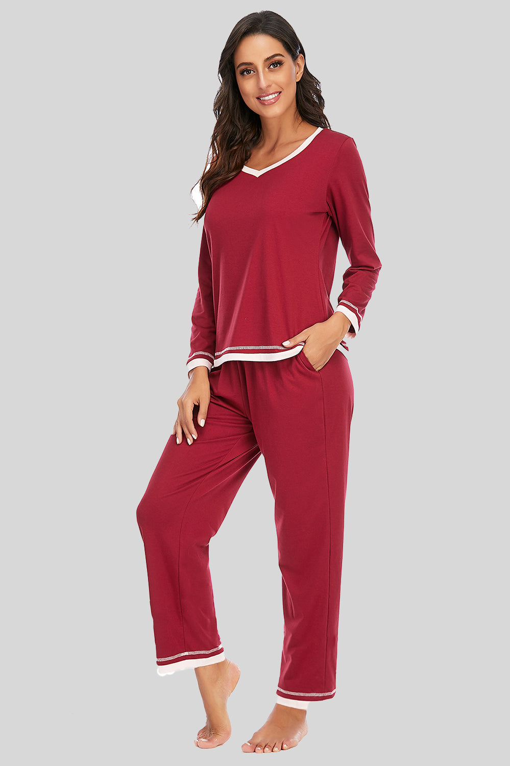 Woman wearing a red pajama set on a gray background