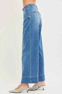 Blue jeans worn by a person on a white background