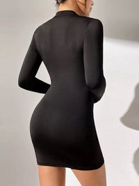 Black long-sleeve dress on a plain background