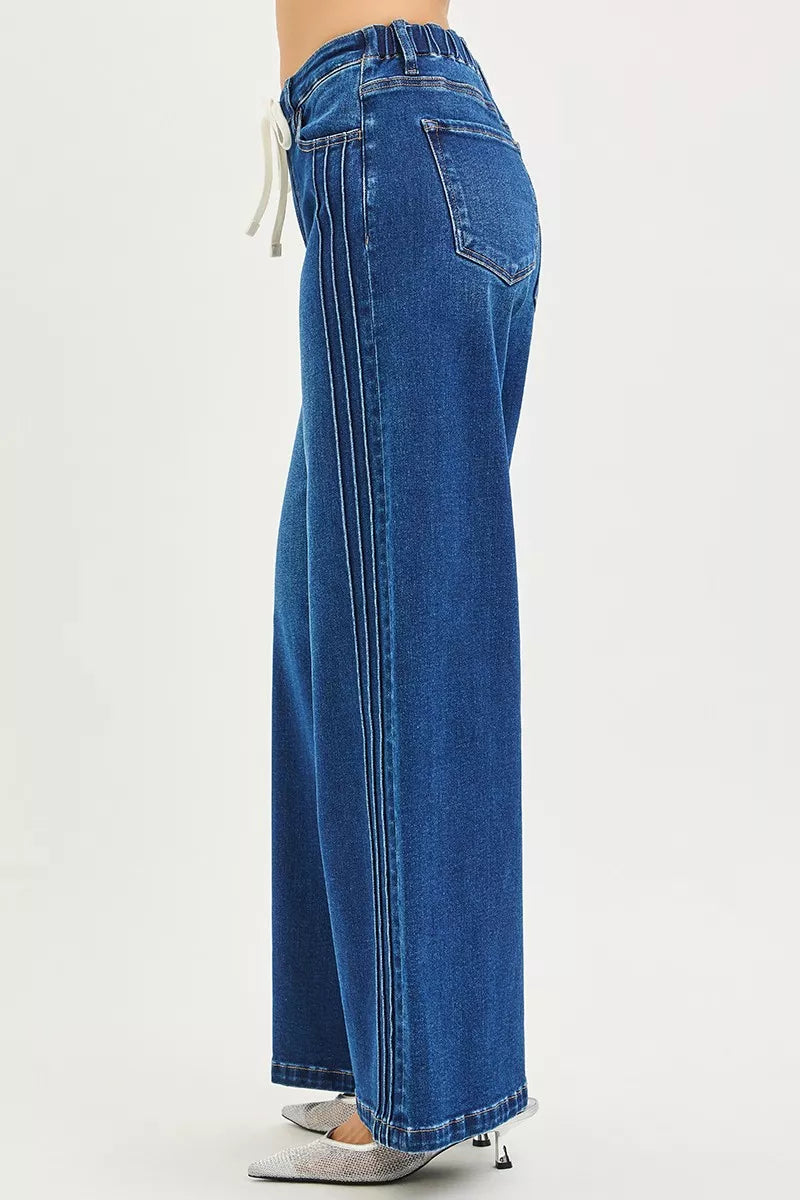 Blue jeans worn by a person on a white background