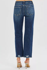 Blue jeans worn by a person on a white background