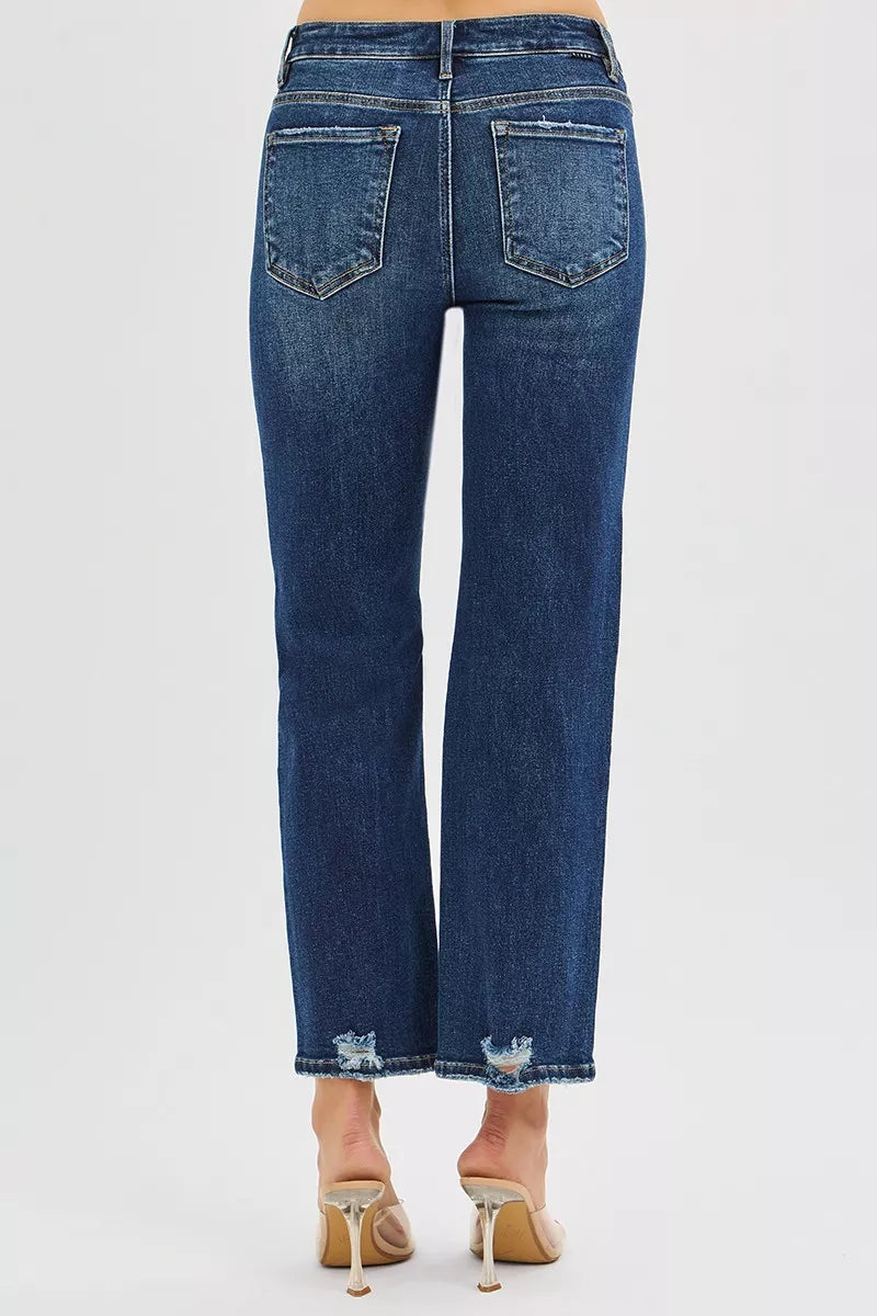 Blue jeans worn by a person on a white background