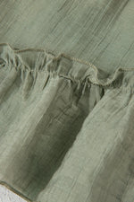 Close-up of green fabric with ruffled edge