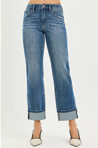 Blue jeans with a rolled hem on a white background