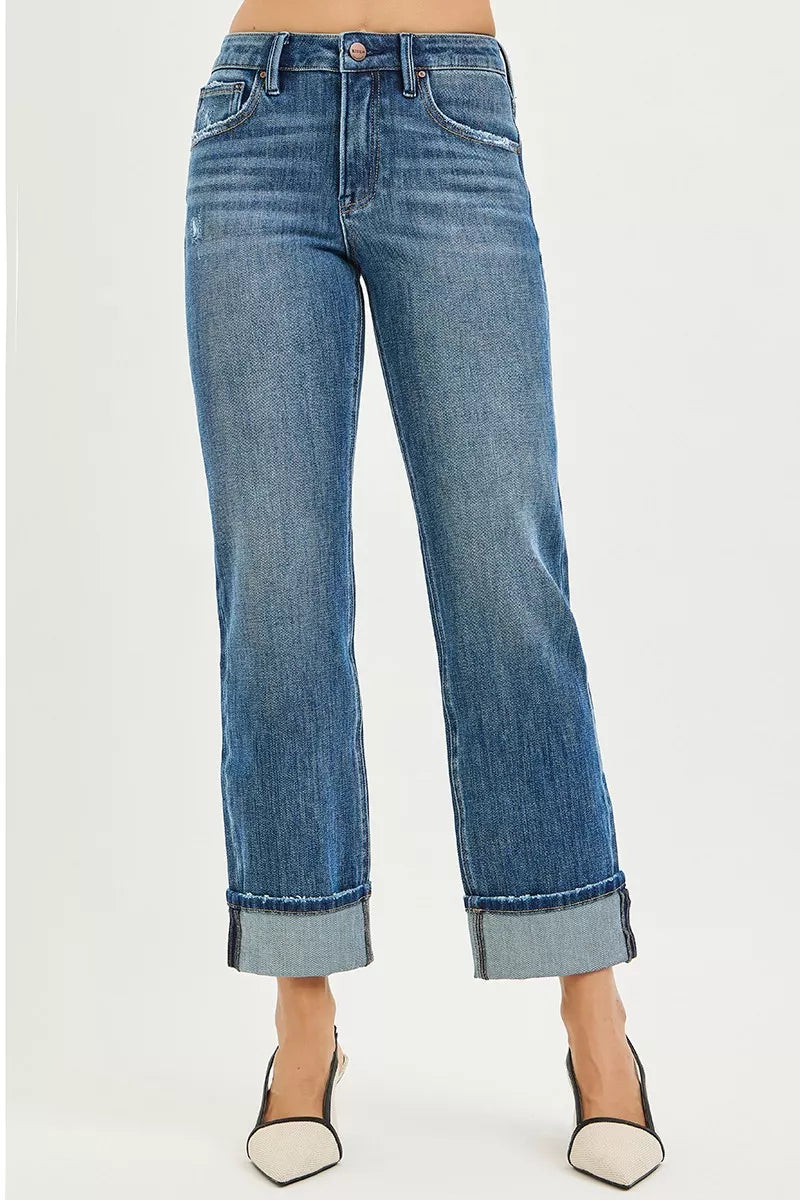 Blue jeans with a rolled hem on a white background