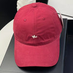 Red cap with a small logo on a black surface