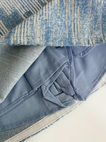 Close-up of blue fabric on a textured surface