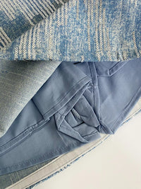 Close-up of blue fabric on a textured surface