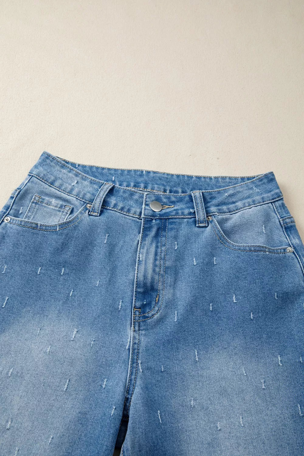 Blue jeans with a beige background