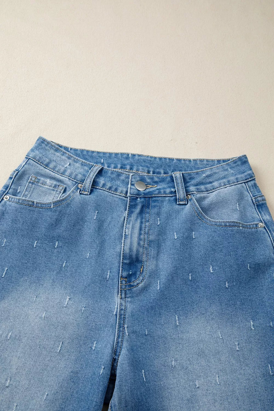 Blue jeans with a beige background
