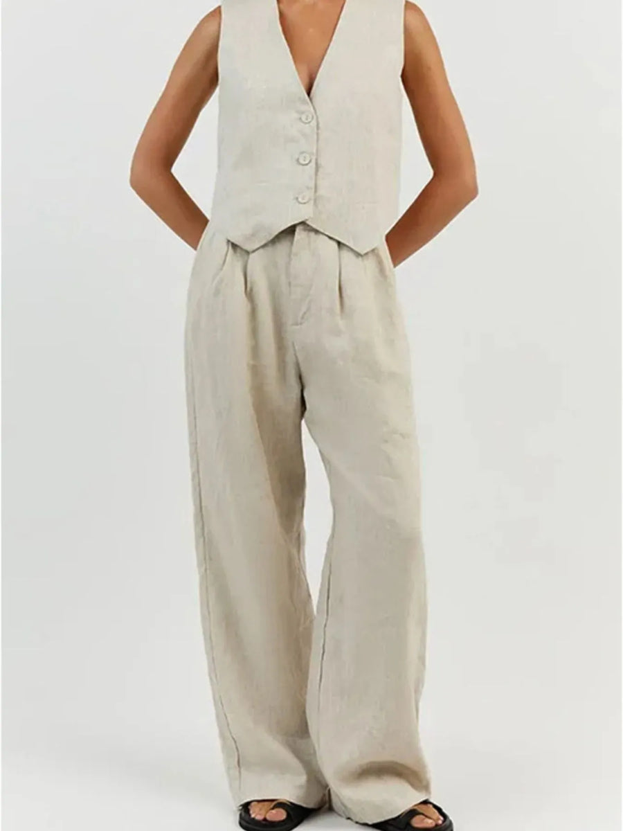 Person wearing a beige vest and wide-leg pants on a white background