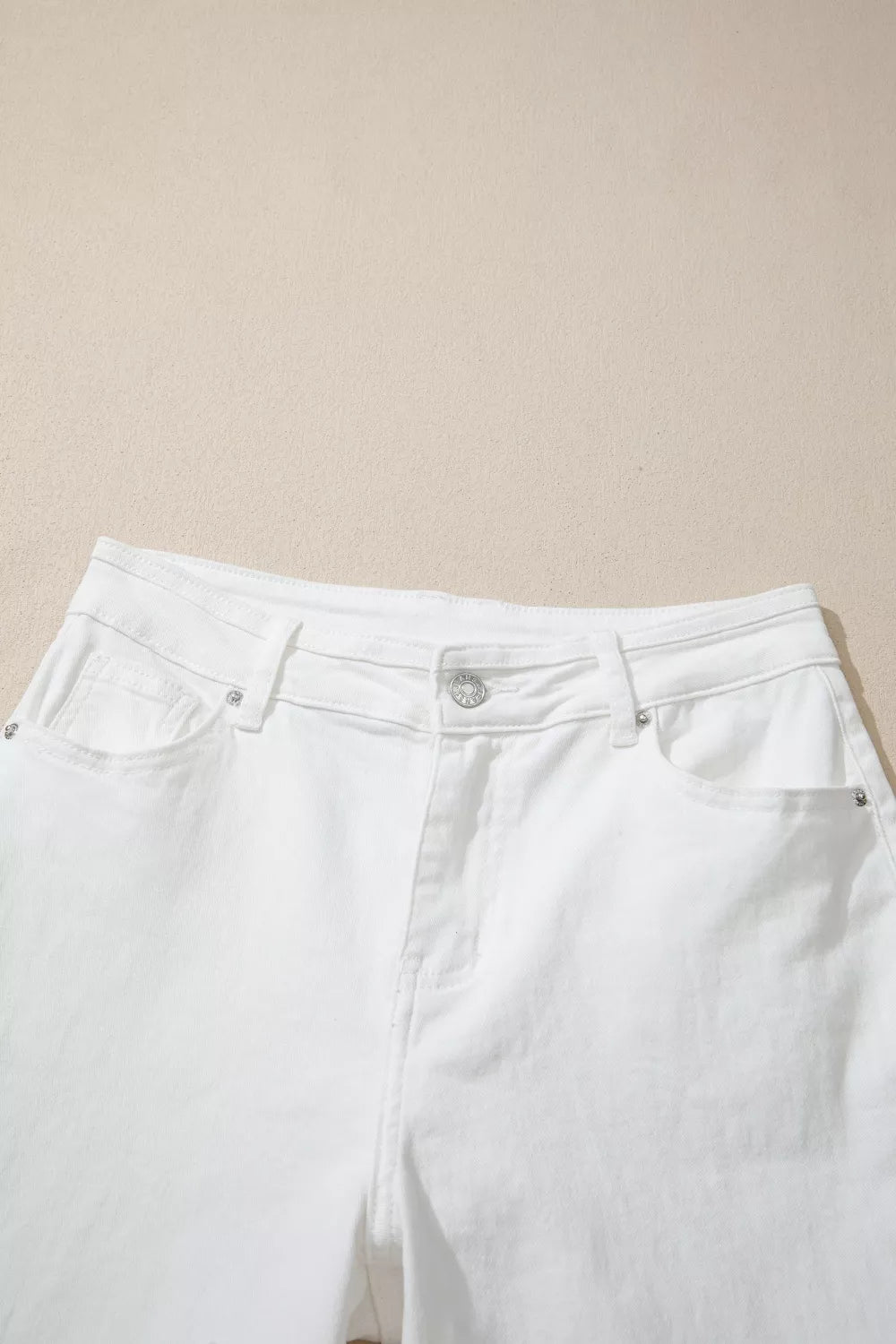 White pants on a beige background