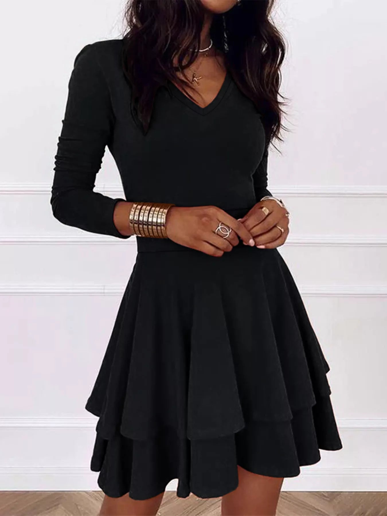 Black dress worn by a person on a white background