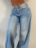 Light blue jeans worn by a person on a plain background