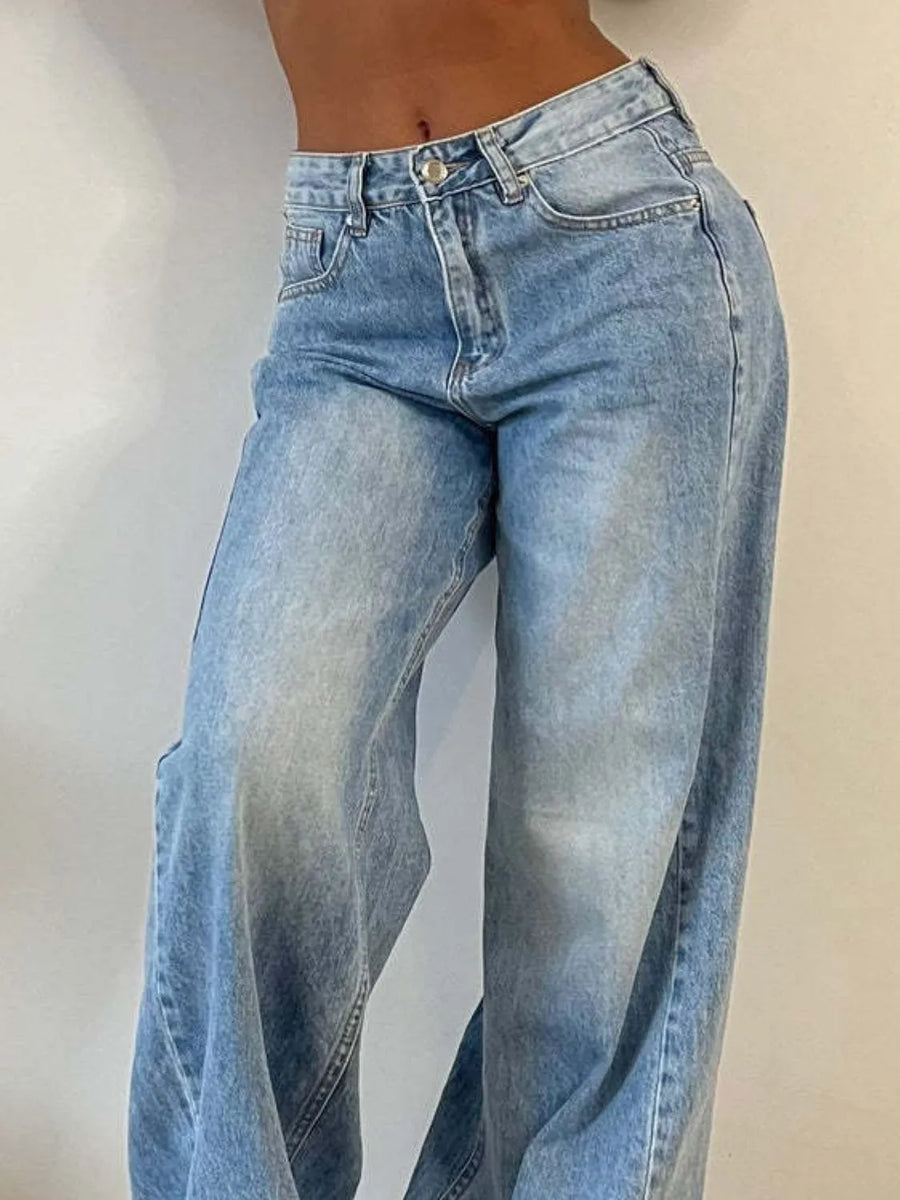 Light blue jeans worn by a person on a plain background