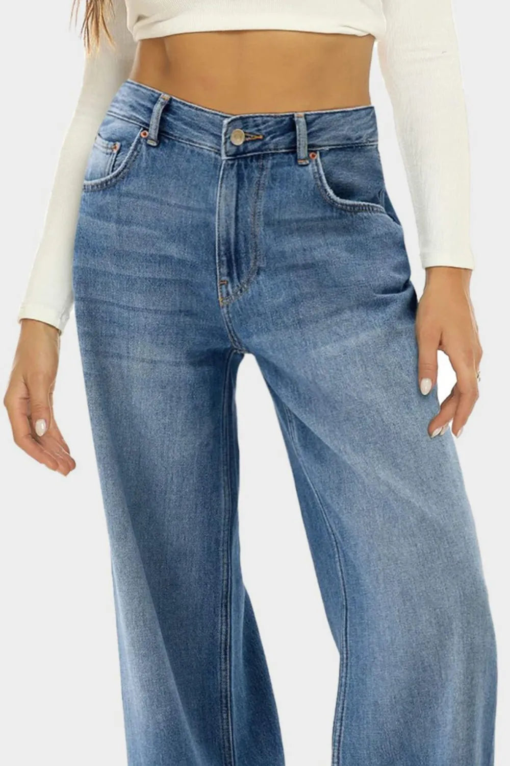 Blue jeans worn by a person on a white background