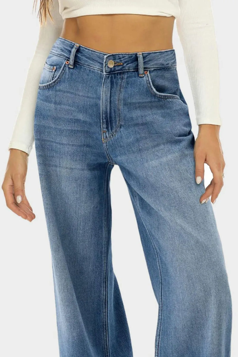 Blue jeans worn by a person on a white background