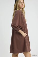 Woman wearing a brown dress on a white background