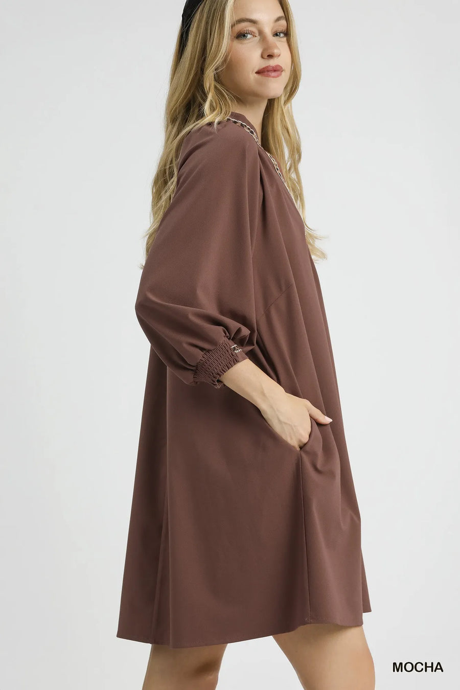 Woman wearing a brown dress on a white background