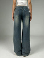 Person wearing wide-leg jeans on a plain background