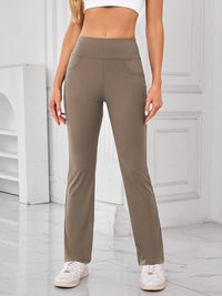 Person wearing beige pants in a minimalistic indoor setting