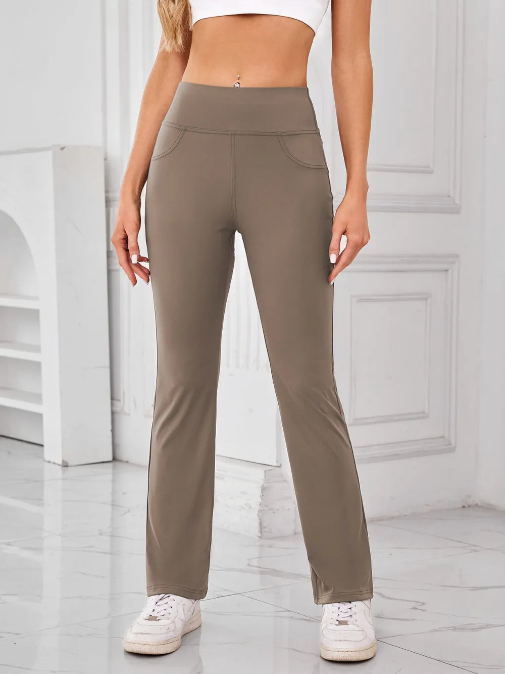 Person wearing beige pants in a minimalistic indoor setting