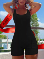 Person wearing a black romper with a red ribbon in the background