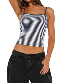 Woman wearing a striped tank top and black pants on a white background