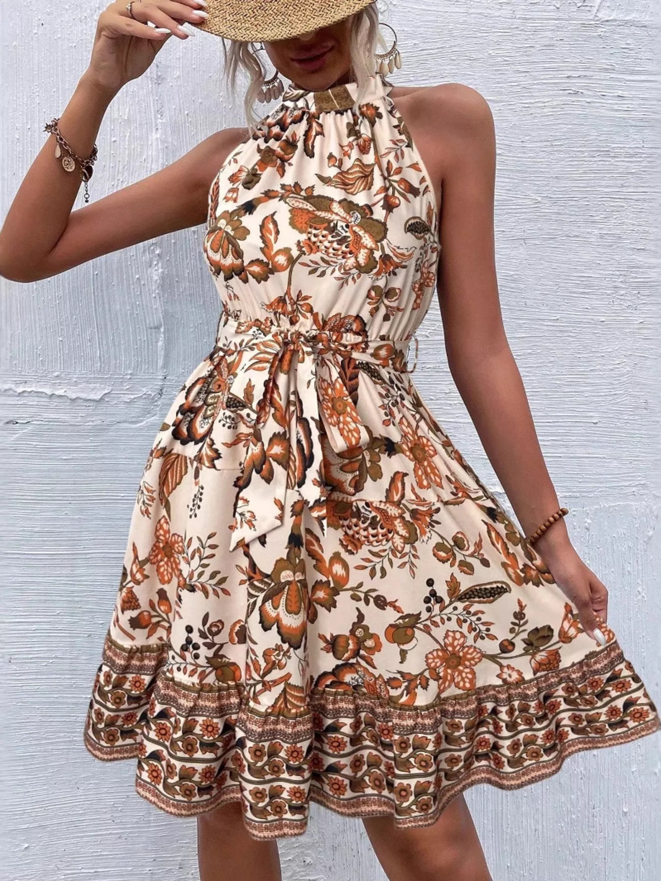 Woman wearing a floral dress with a textured wall background