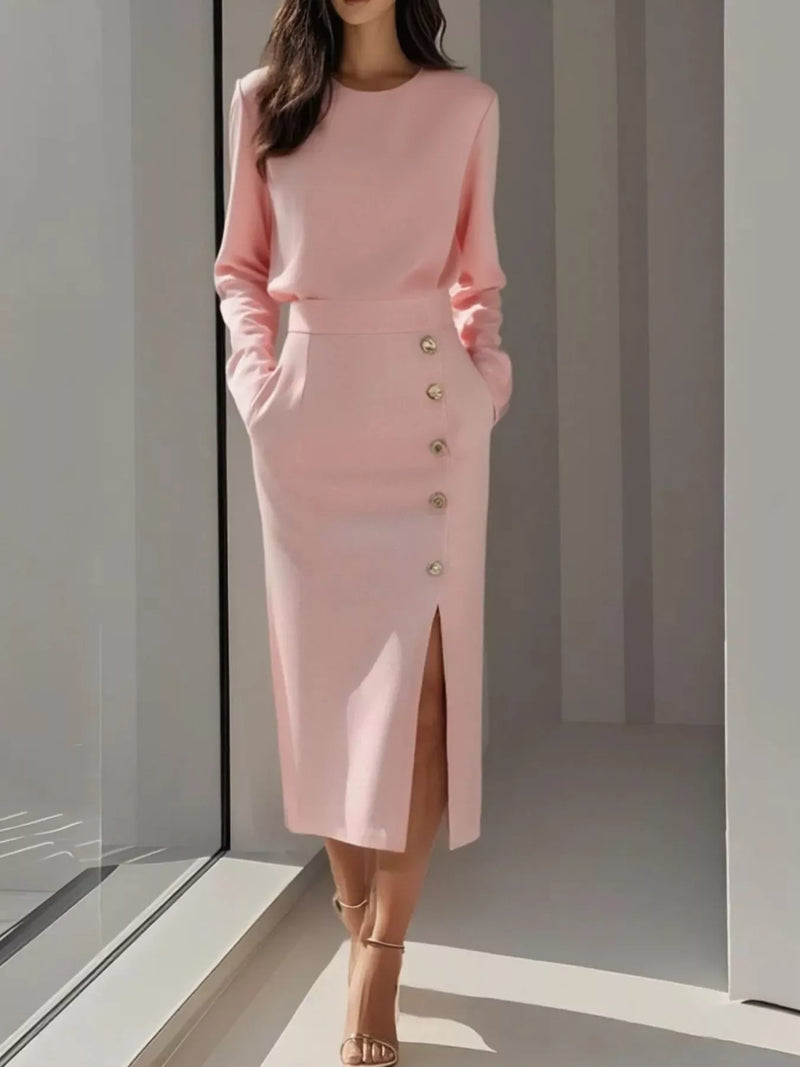 Woman wearing a pink outfit with buttons in a minimalistic setting