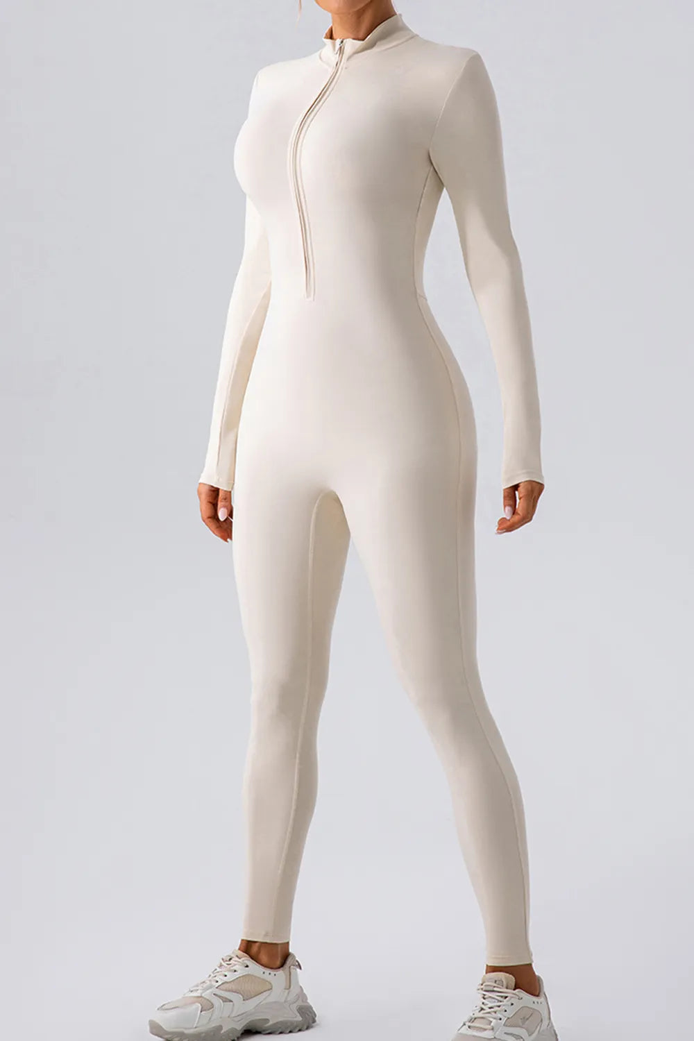 Person wearing a white bodysuit on a light gray background