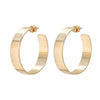 A pair of flat gold-colored metal hoop earrings.