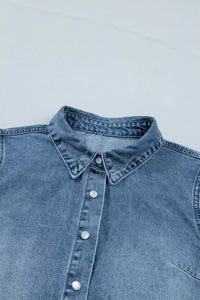 Blue denim shirt collar and buttons on a light gray background