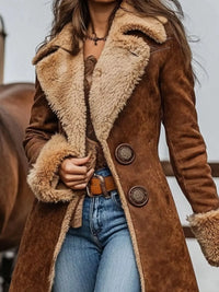 Brown suede coat with fur lining worn by a person, with a blurred background.