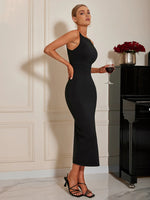 Woman in a black dress holding a glass of red wine in a elegant room.