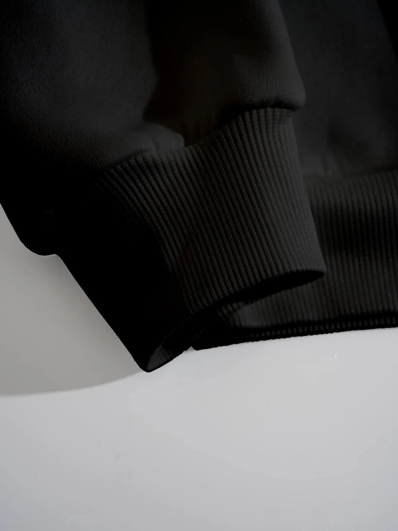 Close-up of a textured black fabric on a white surface