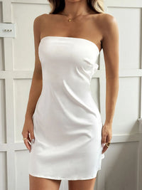 White strapless dress worn by a person against a white background