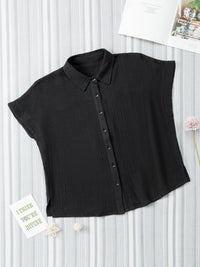 Black sleeveless blouse on a white background