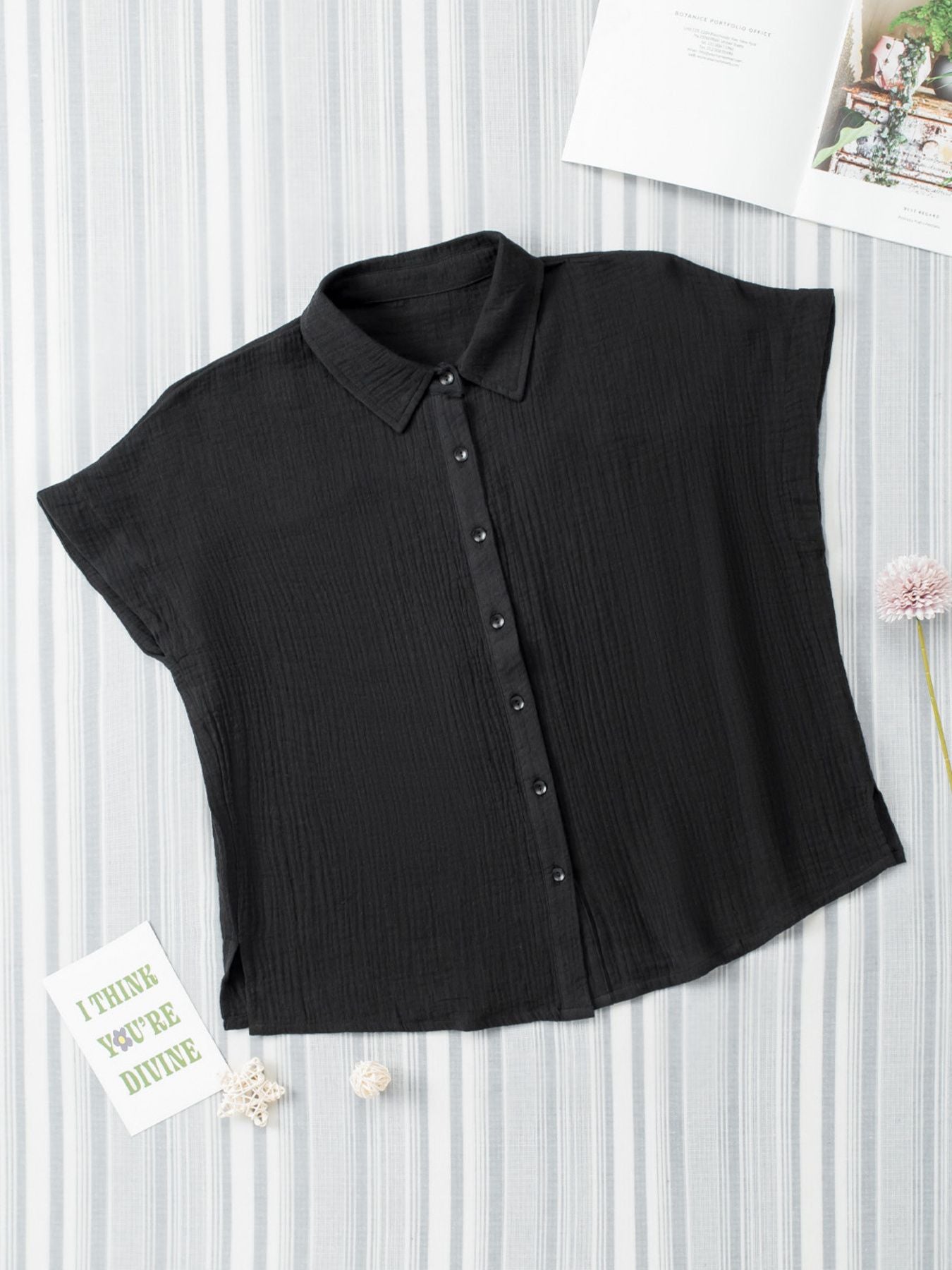 Black sleeveless blouse on a white background