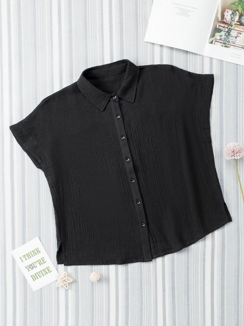 Black sleeveless blouse on a white background