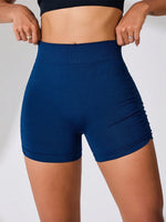 Person wearing blue athletic shorts on a plain background