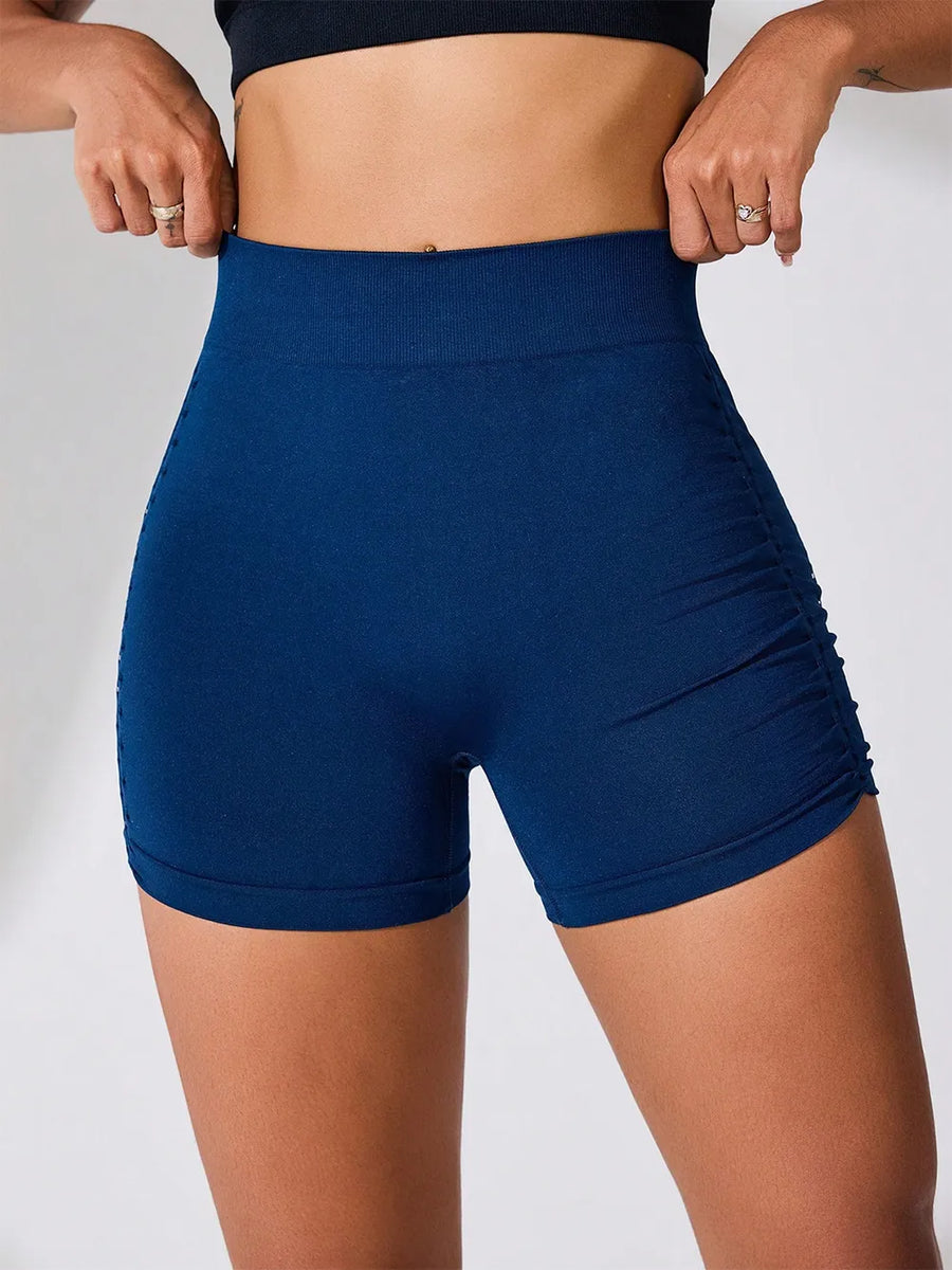 Person wearing blue athletic shorts on a plain background